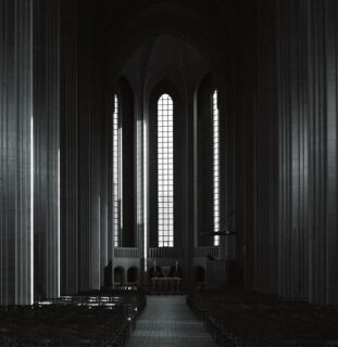 Empty church with rows of wooden pews