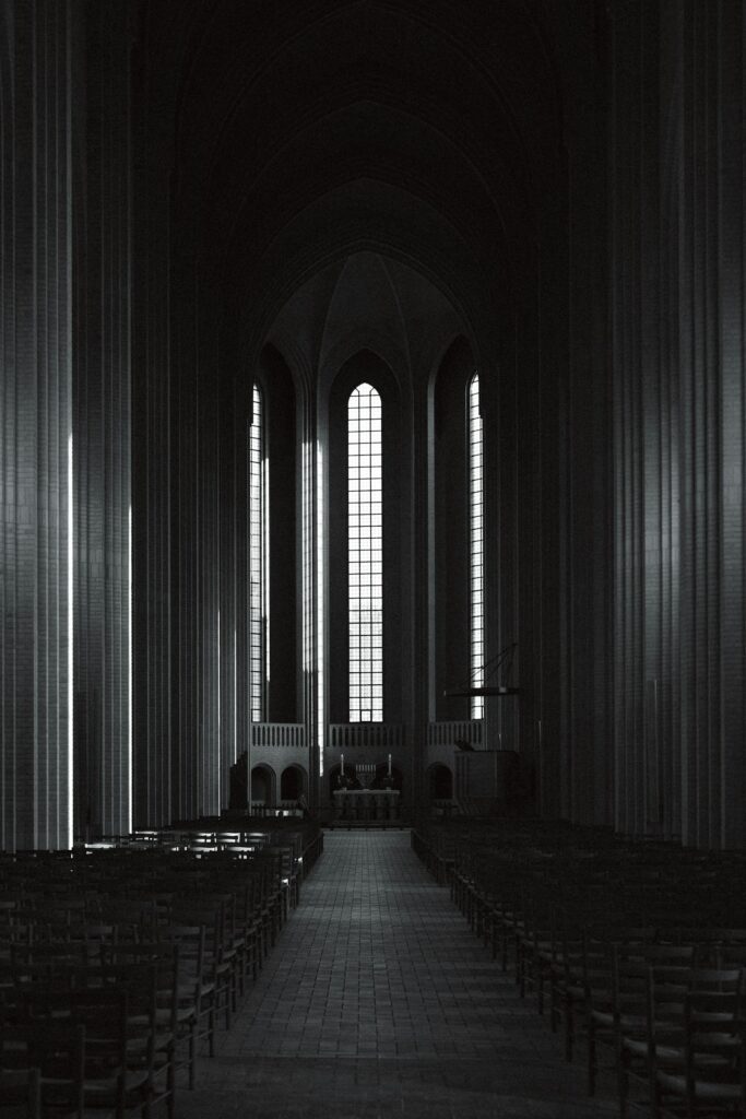 Empty church with rows of wooden pews