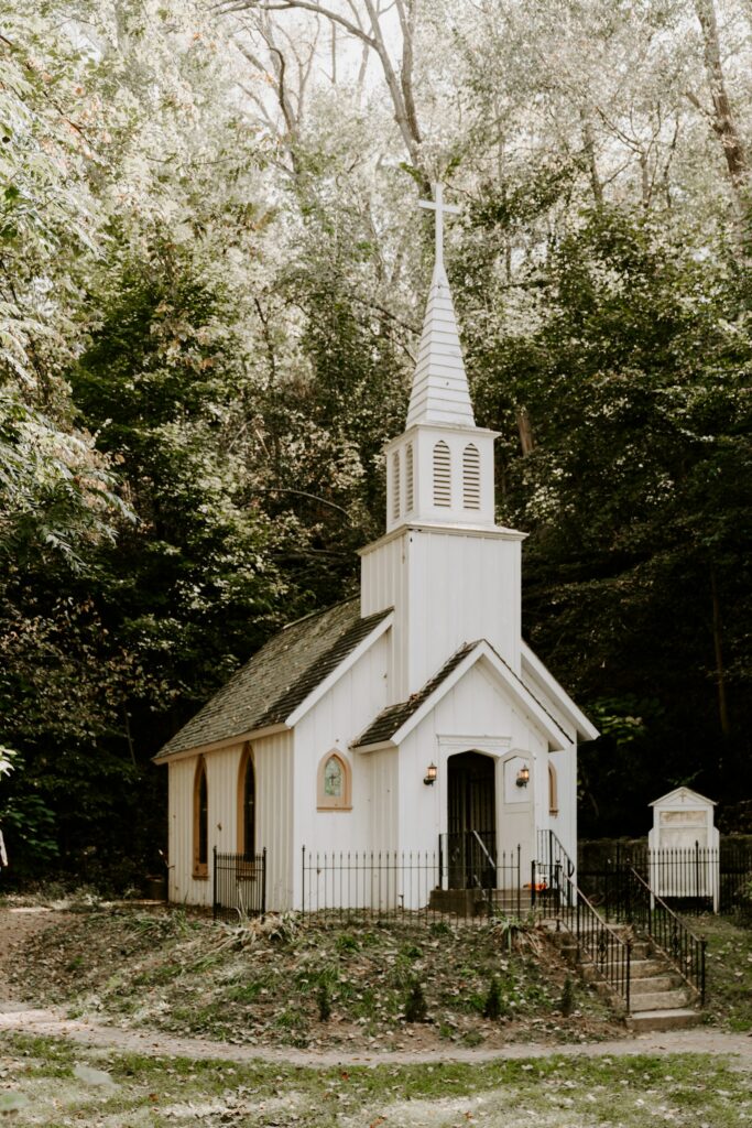 Small white church surrounded by trees